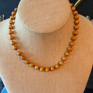 Vintage necklace featuring brown wood like beads